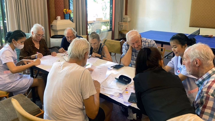 Residents and staff around a table activity.