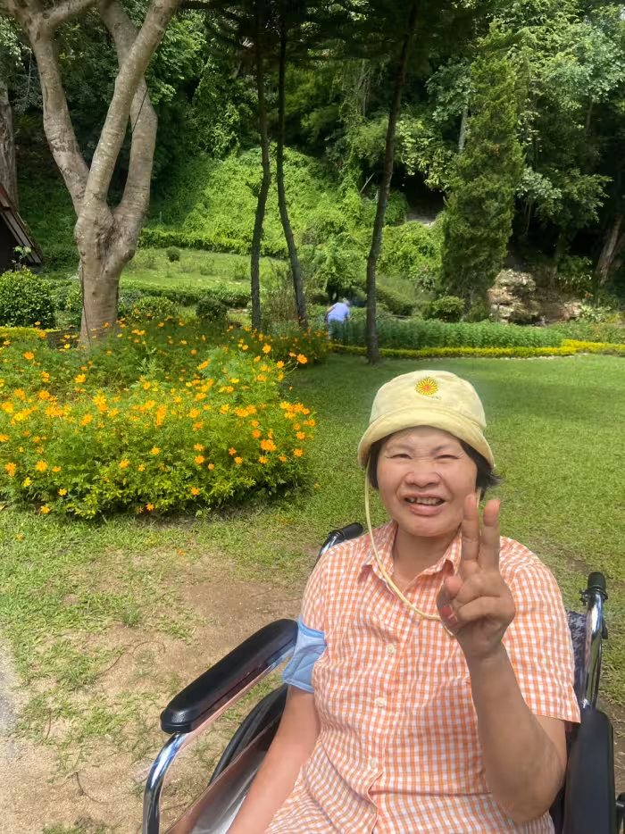 A resident in a sun hat, in the garden.