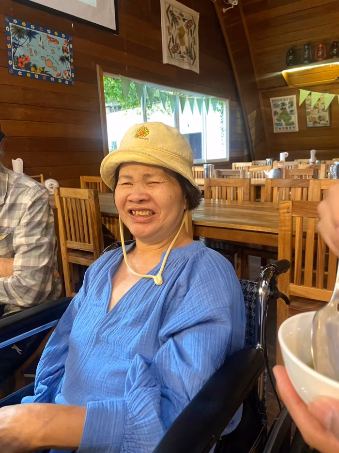 A resident laughing, indoors.