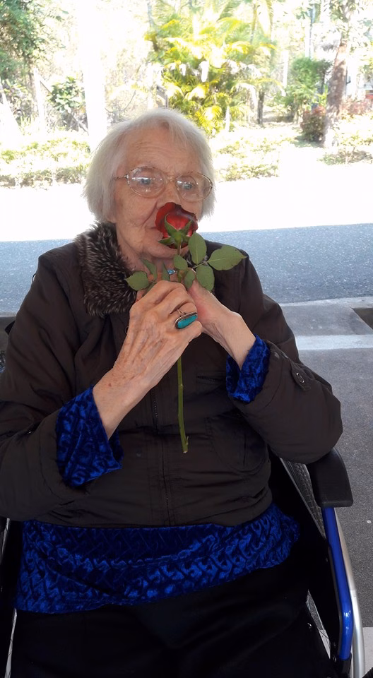 A resident holding a rose.