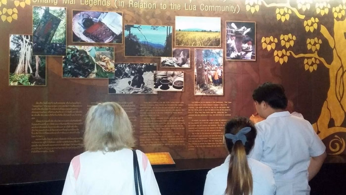 Staff and visitors at a wall display.
