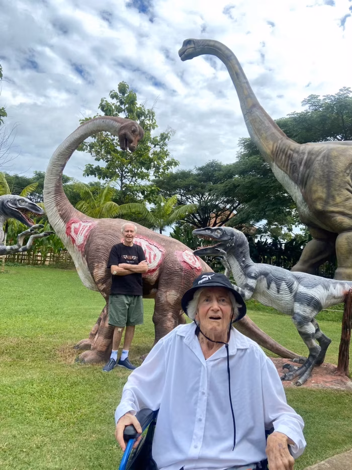 Children posing beside the resort's dinosaur statues.