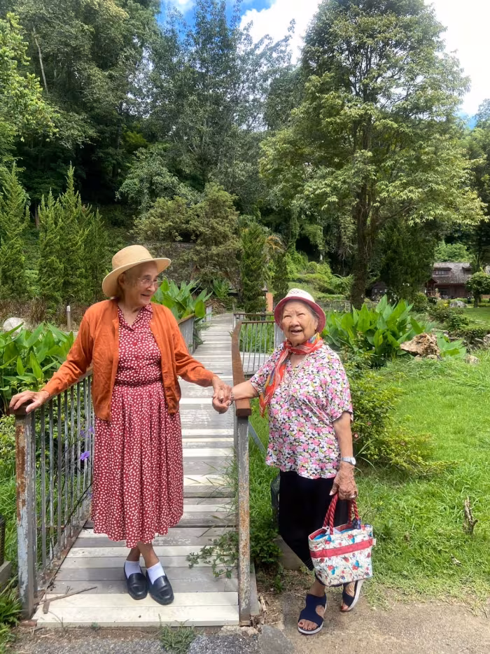 Two residents walking down the garden steps together.