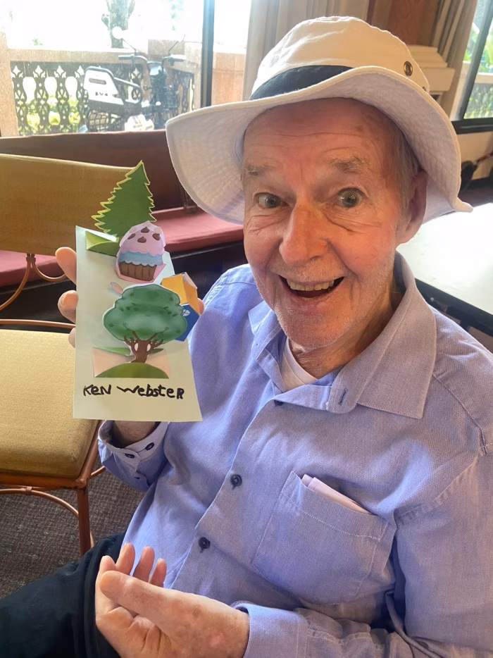 A resident holding a small potted plant.