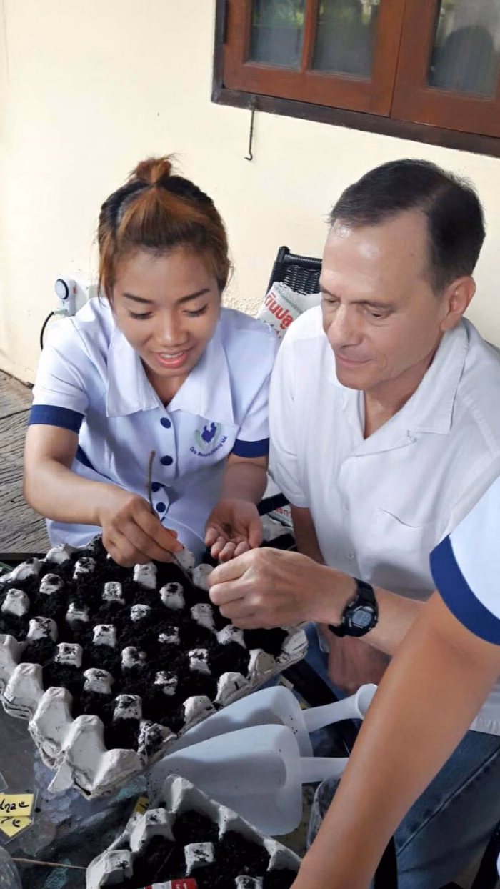 A carer helping a resident with a task, close view.