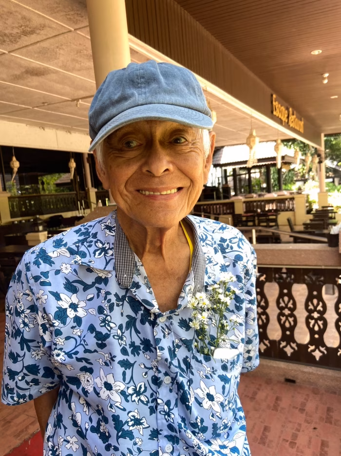 A resident in a sun hat, in the restaurant.