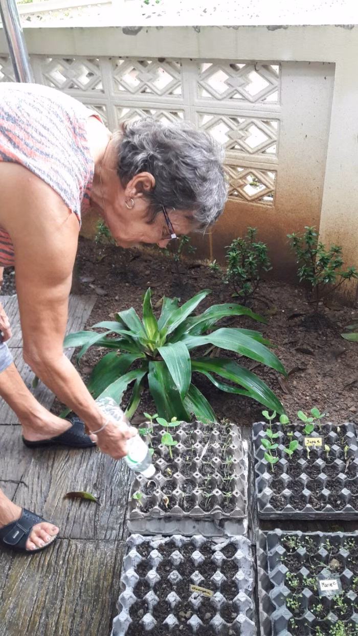 A resident potting plants in the garden.
