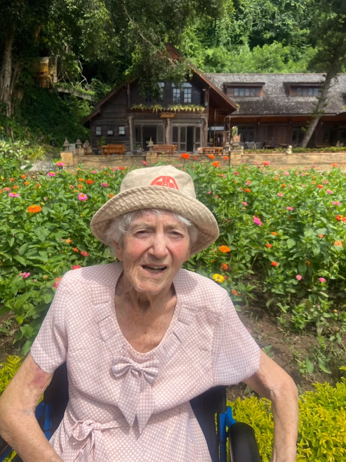 A resident in a sun hat, in the garden.