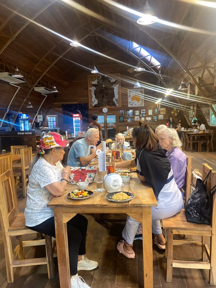 Residents dining together at a long table.