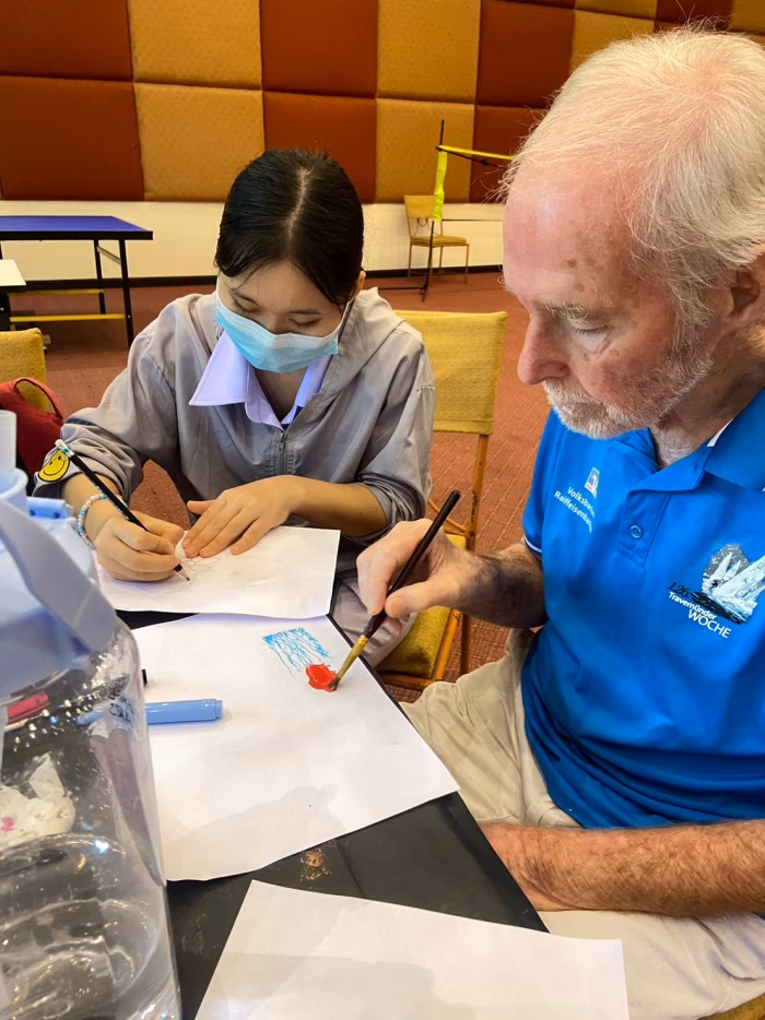 A carer helping a resident with paperwork.