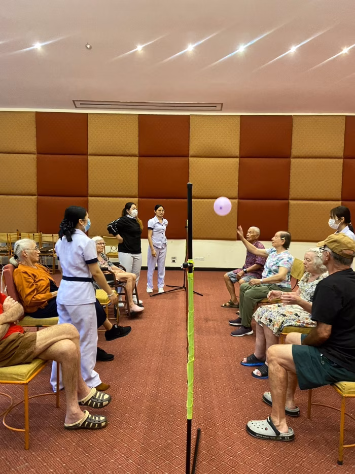 Balloon volleyball, residents and staff in the function hall.