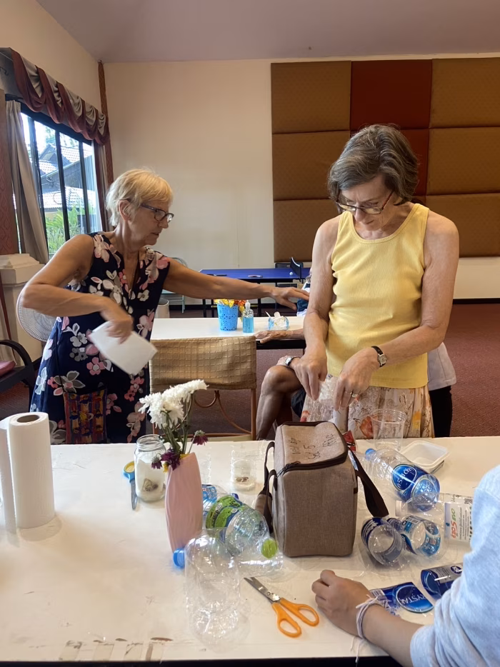 Carers and a resident at a table activity.