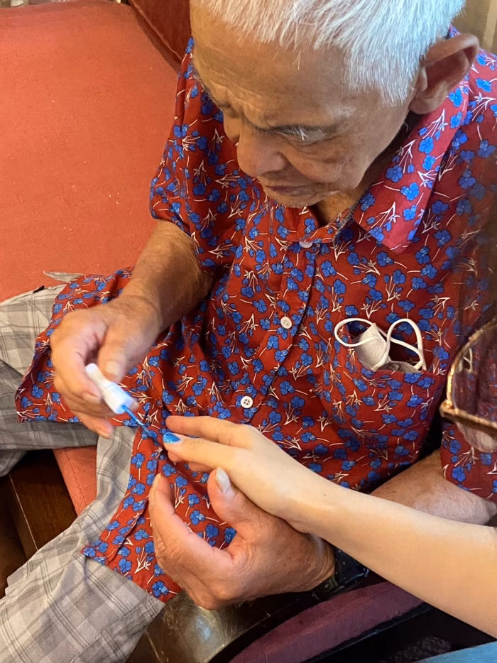 A resident working on a beading activity.