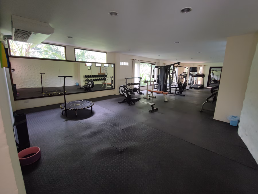 The fitness room, with free weights, a rowing machine and resistance stations.