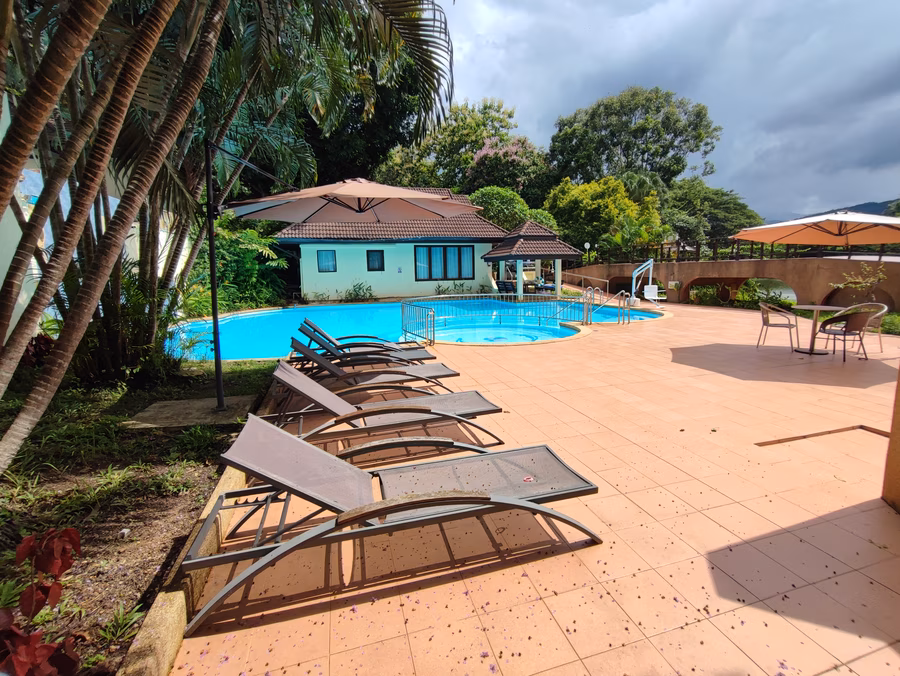 Pool 2, with sun loungers and villas beyond.