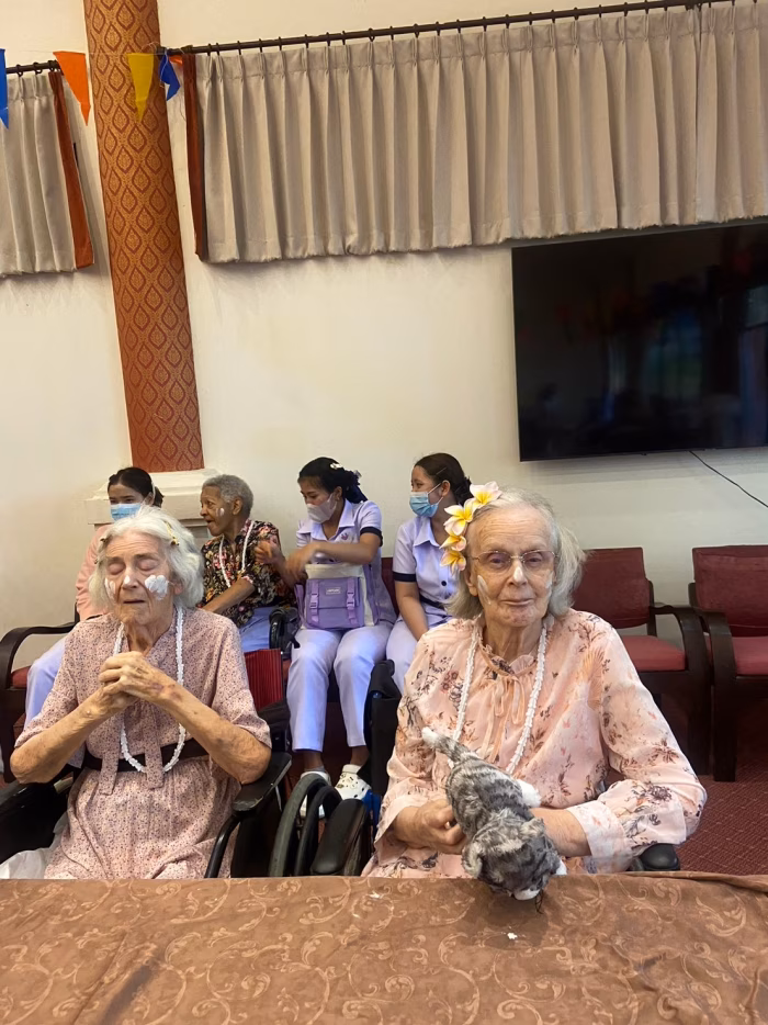 Residents seated for the Songkran celebration.