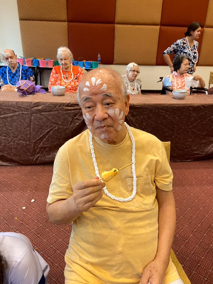 A resident wearing Songkran garlands.